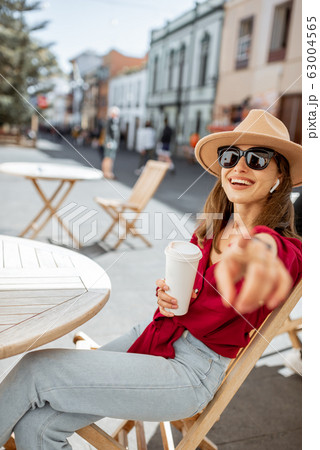 Happy woman resting on the cafe terrace in the old city 63004565