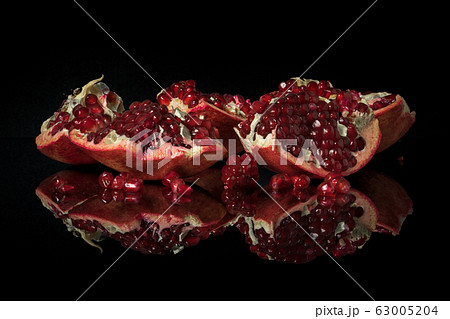 Garnet on a dark mirror table with reflection. 63005204