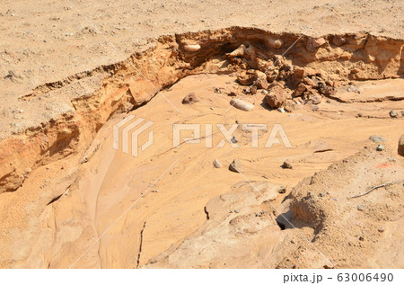 Background of yellow sand with small stones after rain Background of yellow sand with small stones after rain 63006490