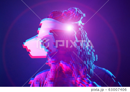 Woman is using virtual reality headset. Neon light studio portrait. Image with glitch effect. 63007406