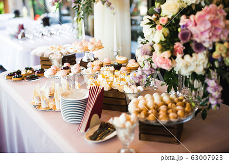 Delicious sweets on wedding candy buffet with desserts, cupcakes 63007923