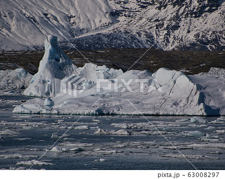 An ice floe drifts in the glacier lagoon An ice floe drifts in the glacier lagoon 63008297