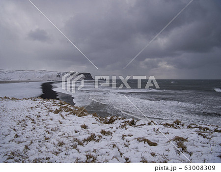 The snowy coast in Iceland with black sand 63008309