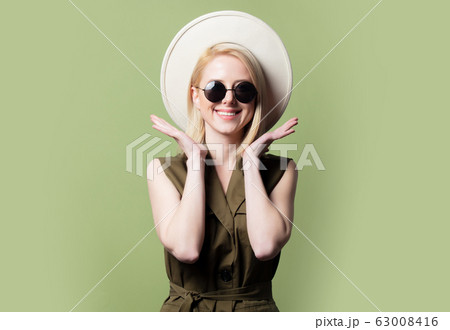 Style blonde woman in sunglasses, hat and sundress Style blonde woman in sunglasses, hat and sundress 63008416
