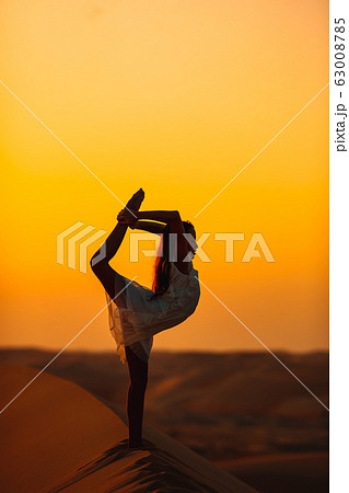 Girl among dunes in Rub al-Khali desert in United Arab Emirates 63008785