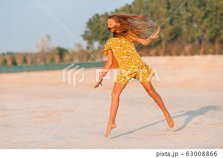 Adorable little girl have fun at tropical beach during vacation Adorable little girl have fun at tropical beach during vacation 63008866