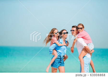 Happy family on the beach during summer vacation Happy family on the beach during summer vacation 63008868