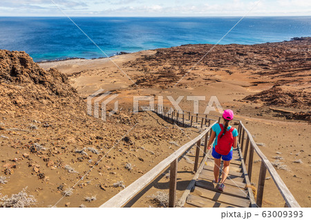 Galapagos tourist hiking enjoying famous Bartolome Island 63009393