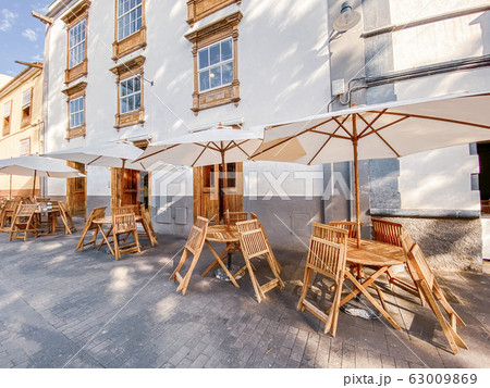 Street view with ancient houses and beautiful cafe terrace 63009869