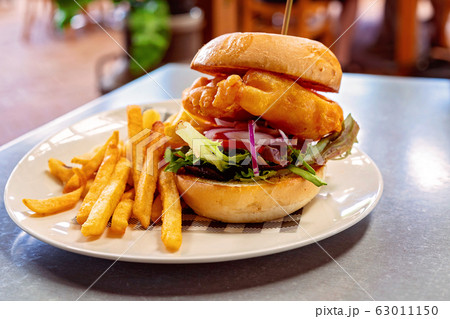 A Battered Fish Burger Served With Chips 63011150