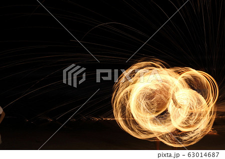 Skill Man playing fireworks by spinning wood pole 63014687
