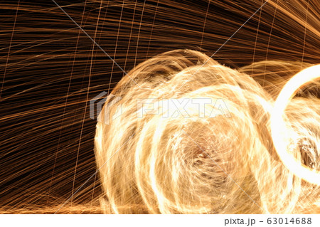 Skill Man playing fireworks by spinning wood pole 63014688