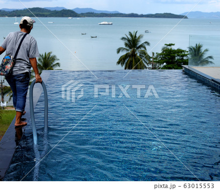 Woman Worker clean private swimming pool with Woman Worker clean private swimming pool with 63015553