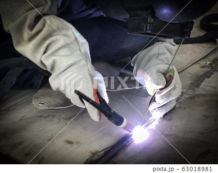 Worker welding stainless tank using tig welder Worker welding stainless tank using tig welder 63018981
