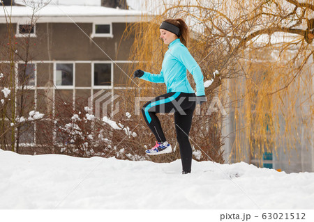 Winter sports, girl exercising in city 63021512