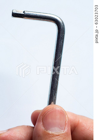 Woman's left using Silver Hexagonal L Key Wrench or Metallic Hex Key or Allen key on White Background, Close up and Macro shot, Hand mechanic tools concept Woman's left using Silver Hexagonal L Key Wrench or Metallic Hex Key or Allen key on White Background, Close up and Macro shot, Hand mechanic tools concept 63023703