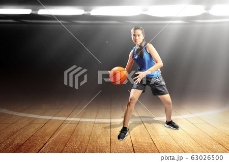 Asian woman basketball player in action with the ball 63026500