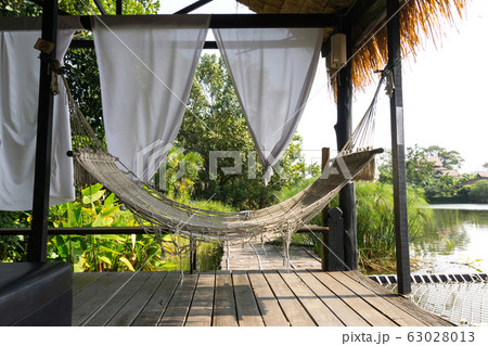 Hammock hanging in wooden hut for relaxing Hammock hanging in wooden hut for relaxing 63028013