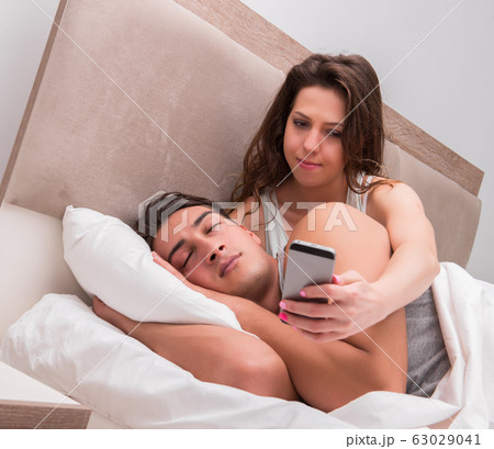 Wife reading his husbands text sms messages Wife reading his husbands text sms messages 63029041