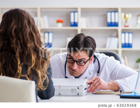 Young doctor in medical insurance fraud concept 63029368