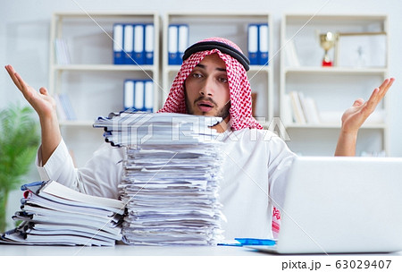 Arab businessman working in the office doing paperwork with a pi 63029407