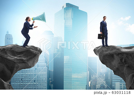Businessman shouting with loudspeaker at others 63031118