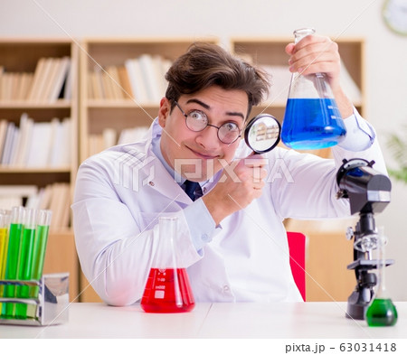 Mad crazy scientist doctor doing experiments in a laboratory Mad crazy scientist doctor doing experiments in a laboratory 63031418
