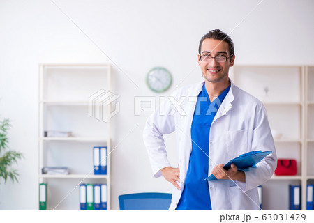 Young male doctor working in the clinic Young male doctor working in the clinic 63031429