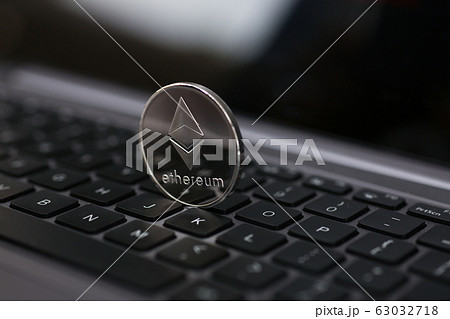 Silver ethereum coin is lying on laptop 63032718