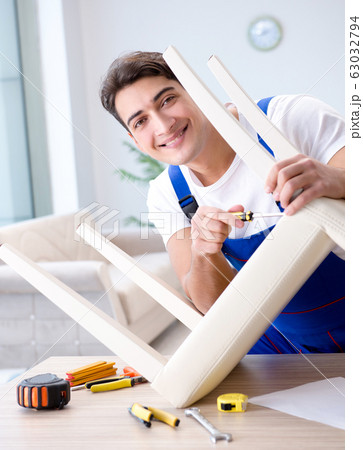 Man repairing chair in the room Man repairing chair in the room 63032794