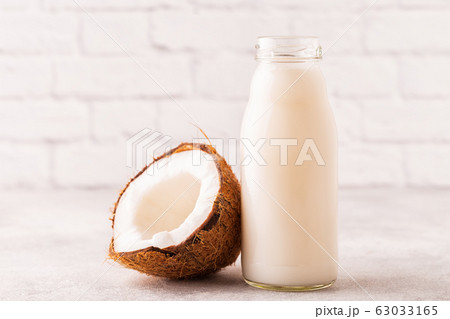 A bottle of coconut milk and coconut A bottle of coconut milk and coconut 63033165