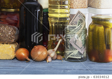 glass jar with paper dollars. against the 63034012