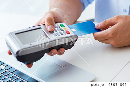 Man processing credit card transaction with POS terminal 63034045