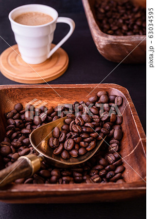 Coffee theme. Hot cups of coffee and plate with coffee beans. 63034595
