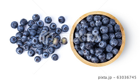 Blueberries in wood bowl isolated on white Blueberries in wood bowl isolated on white 63036745