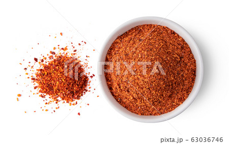 Crushed red chili pepper in white bowl on white 63036746