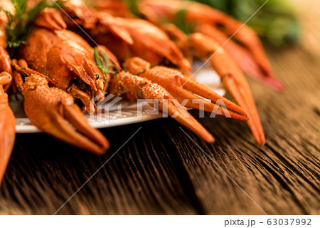 Boiled crayfish on rustic wooden background closeup 63037992