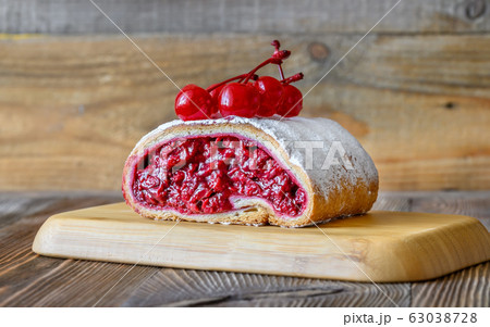Cherry strudel on wooden background Cherry strudel on wooden background 63038728
