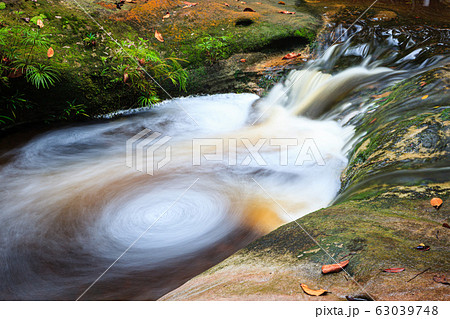Small whirlpool in stream at forest 63039748