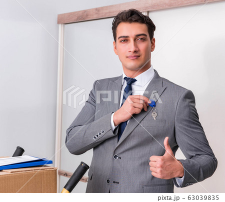 Businessman in real estate concept with home key Businessman in real estate concept with home key 63039835