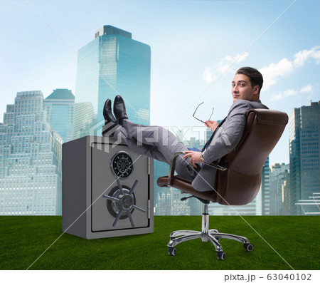 Businessman resting putting leg on safe Businessman resting putting leg on safe 63040102