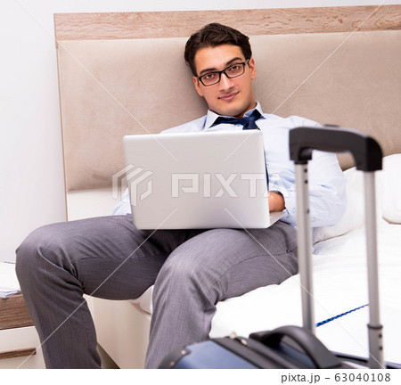 Businessman working during business trip in hotel Businessman working during business trip in hotel 63040108