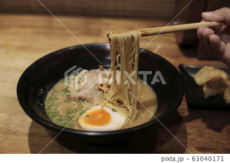Chopsticks on ramen noodles with boiled eggs 63040171