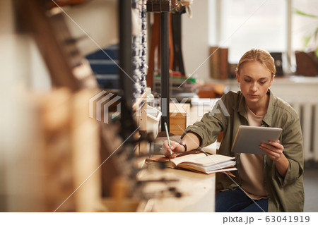 Young Woman Doing Calculations Young Woman Doing Calculations 63041919