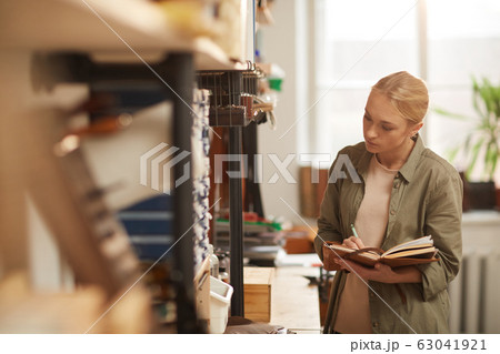 Woman Checking Quantity Of Materials 63041921