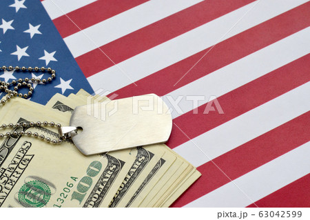 Army identification medallions and dollar bills on Army identification medallions and dollar bills on 63042599