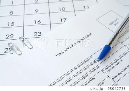 Typical Visa application form and blue pen on 63042733