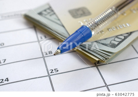 Pen and credit card on many hundred US dollar 63042775