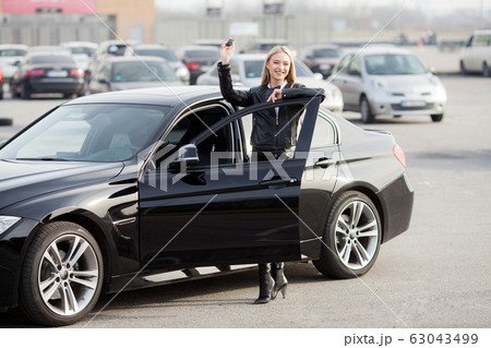 Young happy woman bought new modern car Young happy woman bought new modern car 63043499