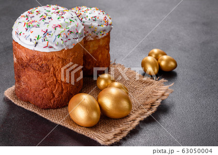 Easter eggs gold and bronze and Easter cake on a 63050004